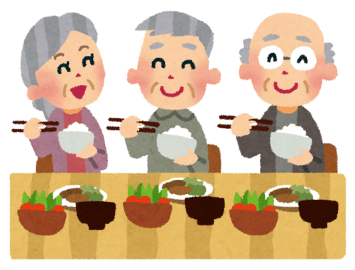 複数の高齢者がテーブルを囲み、笑顔で食事を楽しんでいる様子。